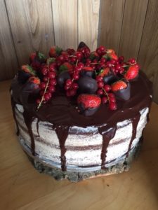 Vanilla and chocolate cake, choclate drip with seasonal fruit